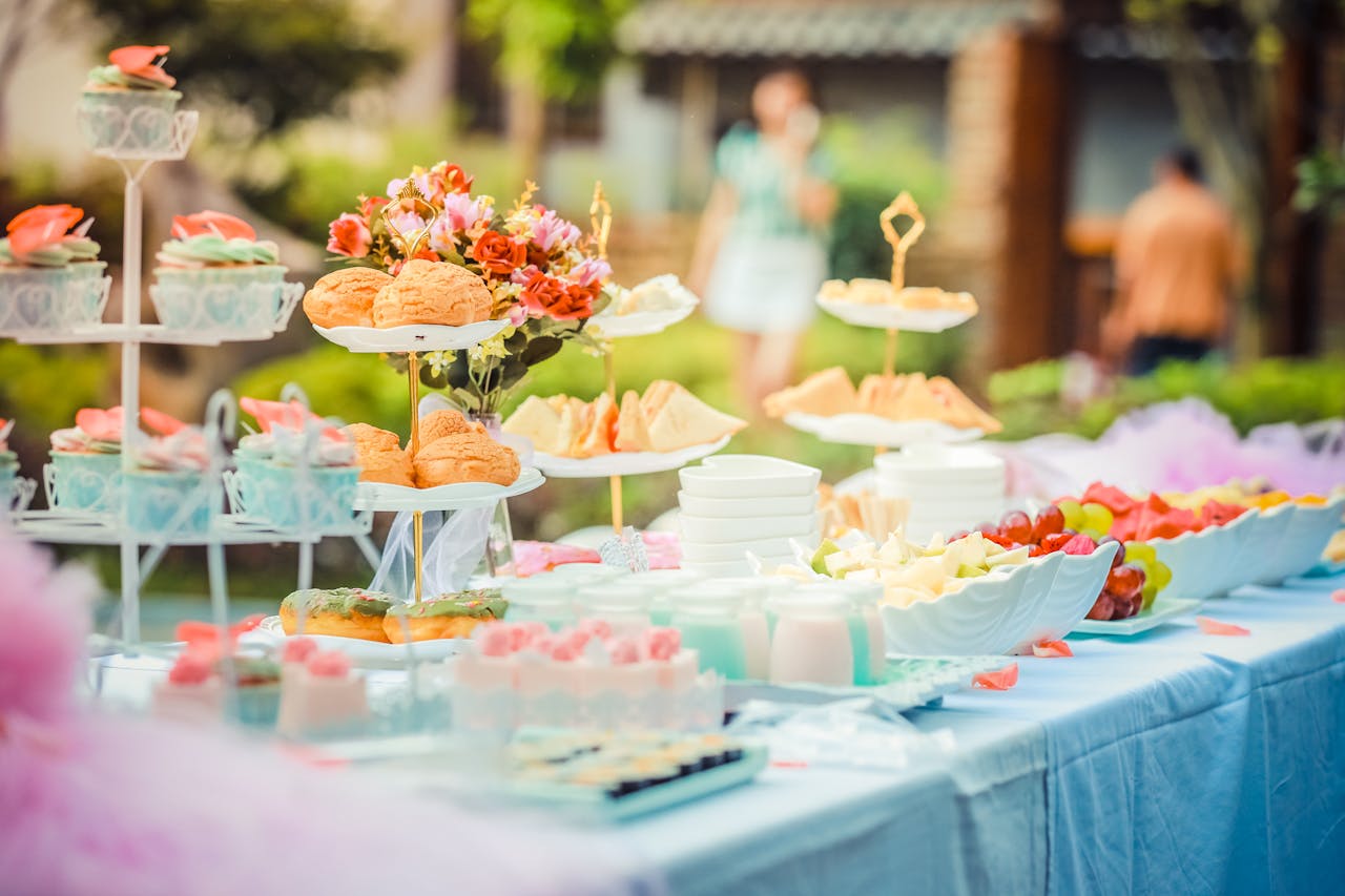 team-01 A vibrant outdoor buffet table showcasing an array of colorful pastries and fruits, perfect for parties.